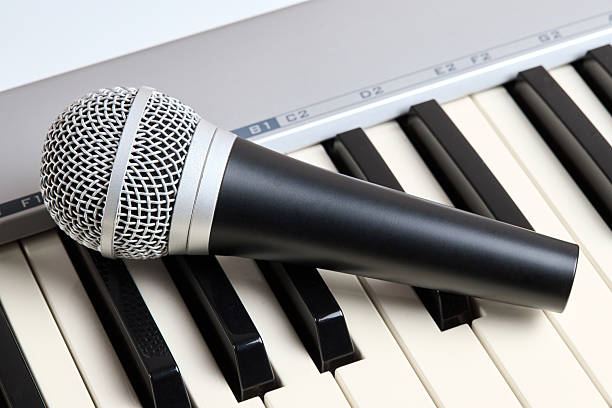istock Microphone on midi piano keyboard keys. Recording studio concept. 2213590340