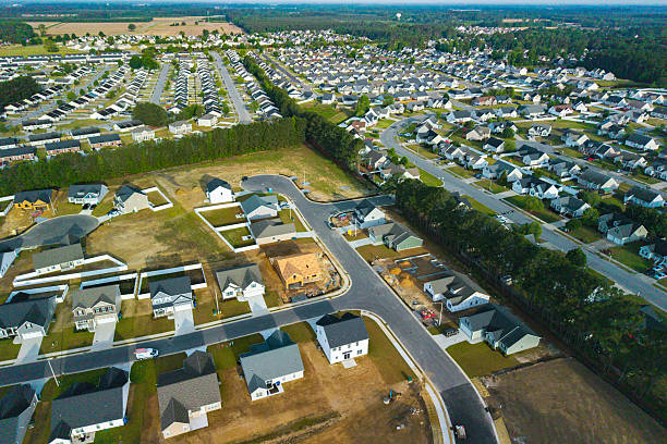 istock New Development Neighborhood - House Under Construction - Wide Shot 2213592355