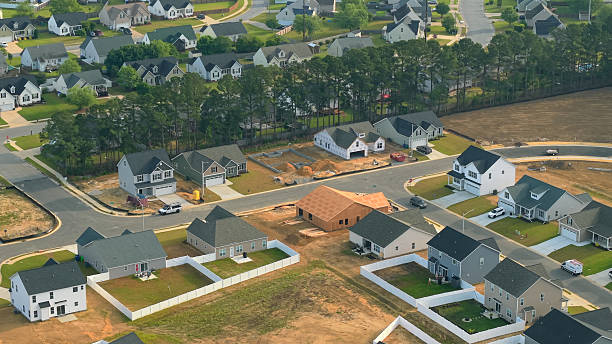istock New Development Neighborhood - House Under Construction - Wide Shot 2213592363