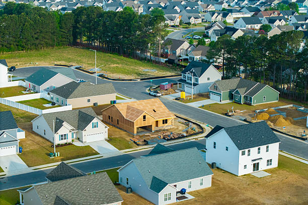 istock New Development Neighborhood - House Under Construction - Wide Shot 2213592607