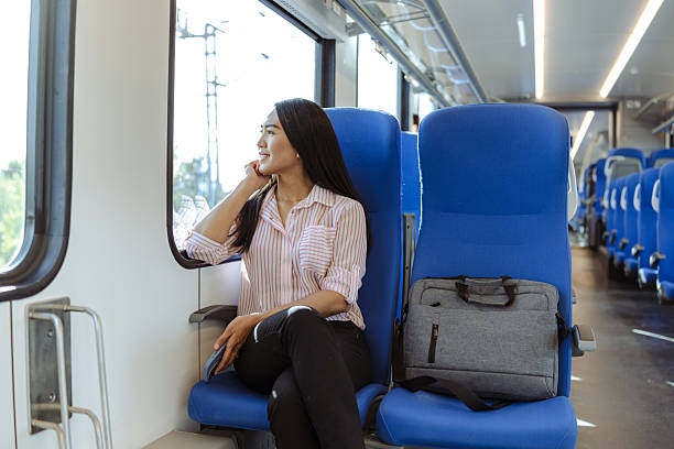 istock Businesswoman commuting by train while gazing outside and reflecting thoughtfully 2213592608