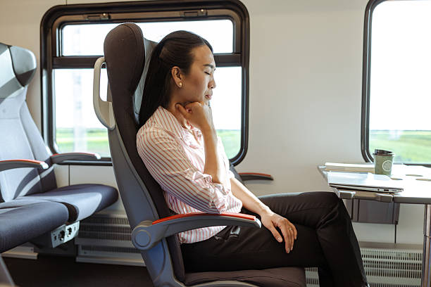 istock Woman  sleeping during train travel under soft natural light 2213592880