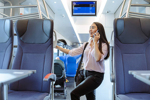 istock Woman using smartphone on train journey in modern comfortable interior 2213592882