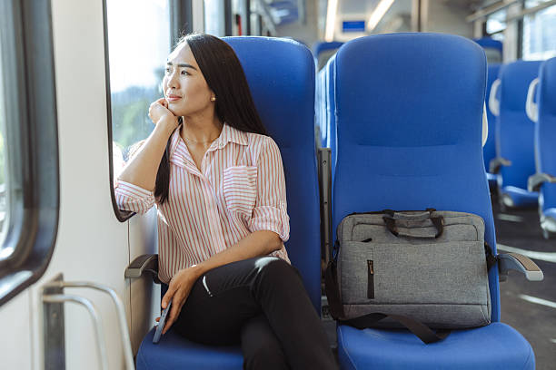 istock Businesswoman commuting by train while gazing outside and reflecting thoughtfully 2213593475