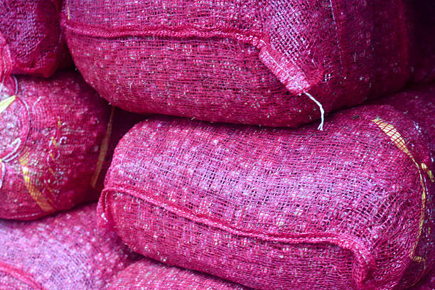 stack of red onion in bags