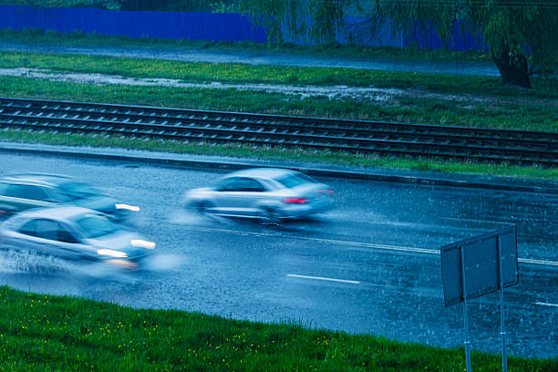 istock Heavy rain on road. Vehicle traffic 2213594194