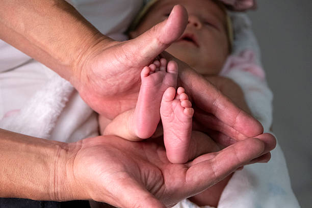istock Baby girl's feet 2213595834