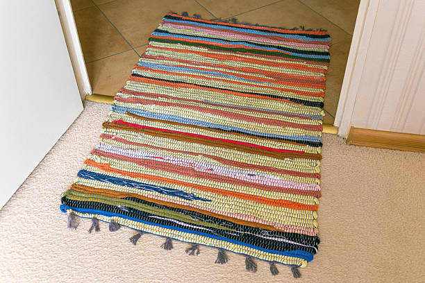 istock Colorful woven doorway rug on carpet and tile transition 2213596071