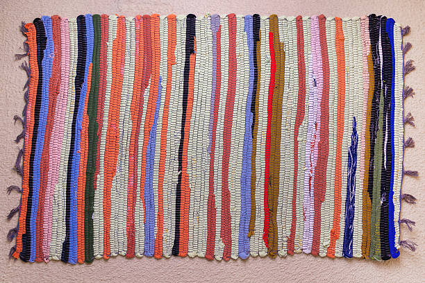 istock Colorful woven rug with striped pattern on carpeted floor 2213596072