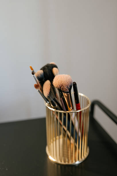 Makeup Brushes in Elegant Gold Holder on Display