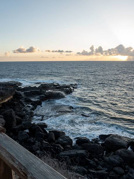 istock Rocky coastline at sunset with waves and clouds. 2213596699