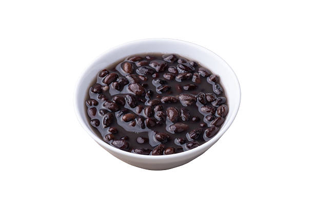 istock Cooked black beans in a bowl isolated over white background 2213596844