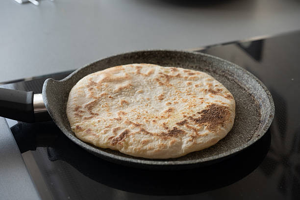 istock Pita bread cooking in a pan on a modern kitchen 2213598819