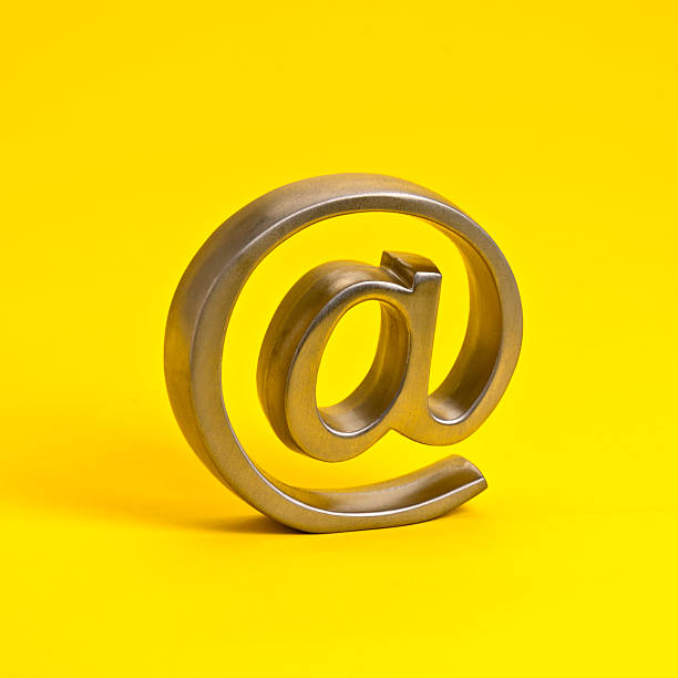 istock @ Symbol Isolated on Yellow Background 2213599971