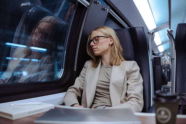 istock Female commuter sleeping in train during the night ride 2213608361