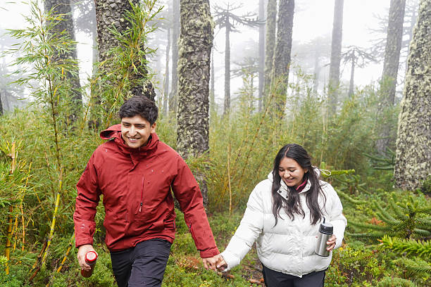istock Young couple enjoying a trek through misty chilean forest 2213610721