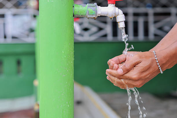 istock man's hand washing hands with bokeh background 2213612788
