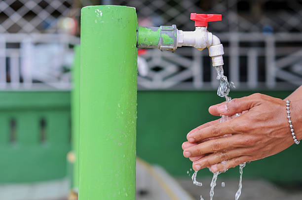 istock man's hand washing hands with bokeh background 2213612795