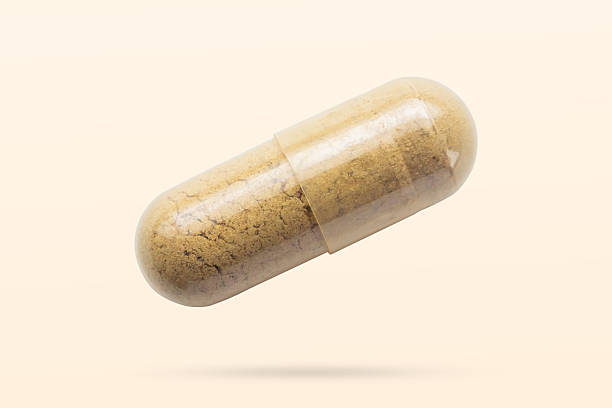 istock Herbal medicine capsule flying on brown background 2213624905