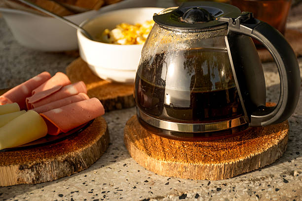 istock breakfast table on sunny day outside with focus on cold coffee pot and rustic wooden pads 2213628420