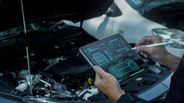 istock Man looking at details with technology about smart maintenance system inspection and maintenance in modern car garage. Car mechanic working with smart car maintenance software. 2213644416