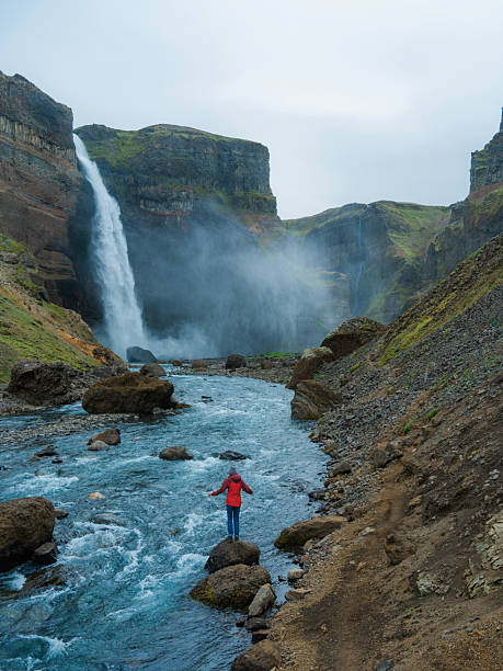 istock Woman looking at Haifoss  waterfall in Iceland 2213645196