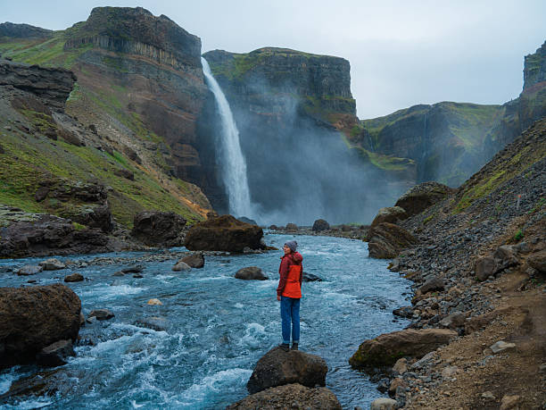 istock Woman looking at Haifoss  waterfall in Iceland 2213645199