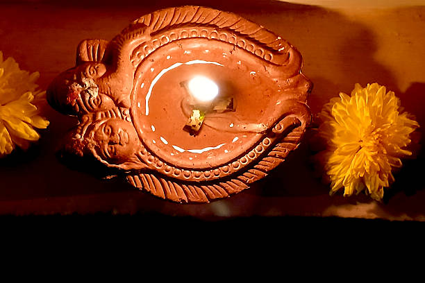 istock Lighted Oil Lamp and Flowers 2213649018