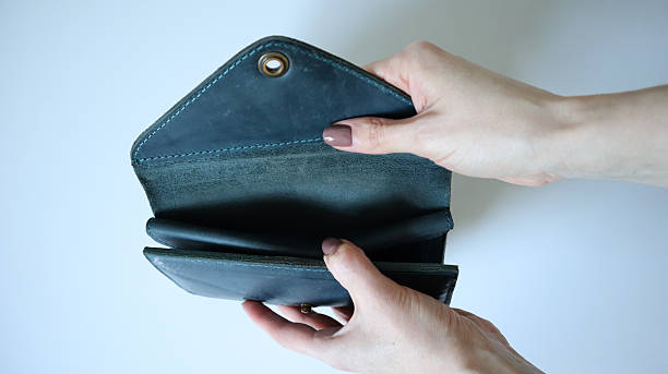 istock Female hands open the wallet, handbag. White background. White hands, light brown nail. Crazy horse leather. Photo. 2213652525
