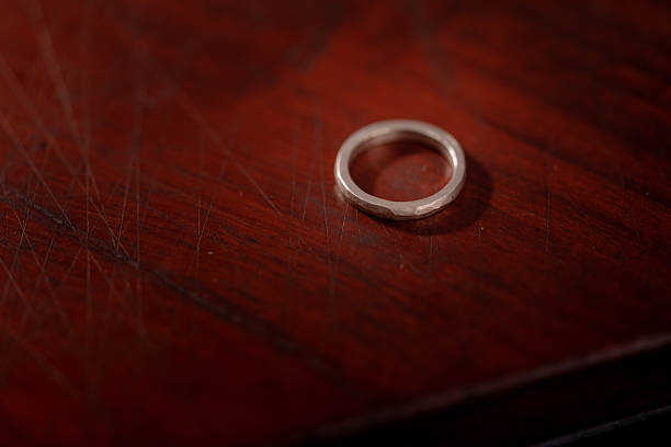 istock Hand-Forged Silver Ring with Hammered Texture on Wooden Surface 2213654611