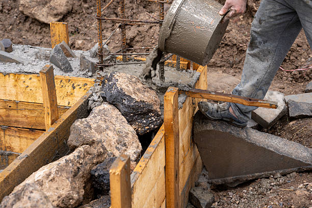 istock Manual pouring of concrete into the foundation 2213656890