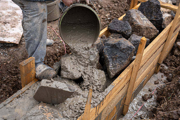 istock Manual pouring of concrete into the foundation 2213657021
