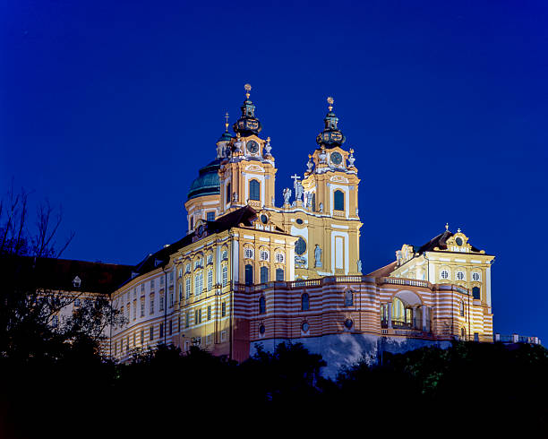 Melk Abbey is a stunning Benedictine monastery in Austria. At night, its baroque architecture is beautifully illuminated, creating a magical atmosphere.