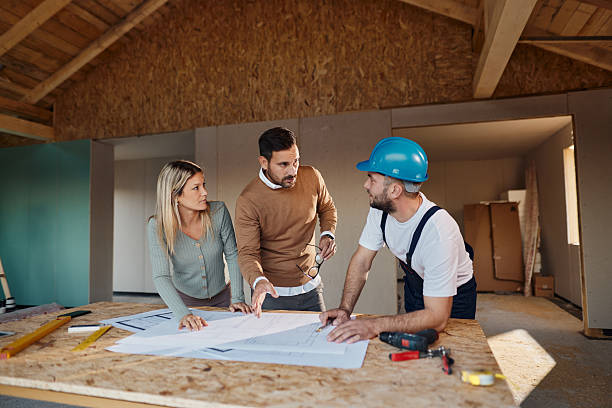 istock Couple talking about blueprints with their construction worker. 2213658772