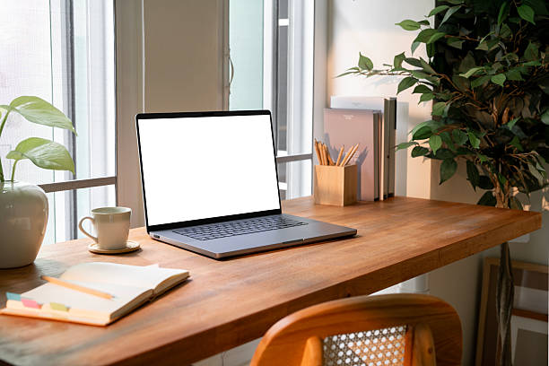istock Laptop computer on wooden table, minimal home office concept. 2213659598
