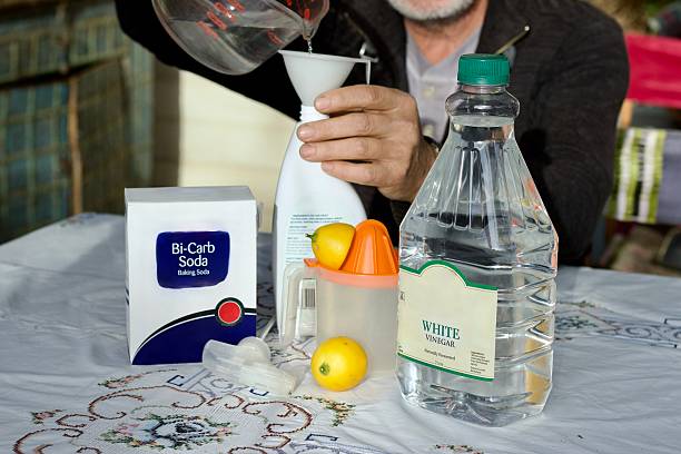 Person making their own cleaning liquid