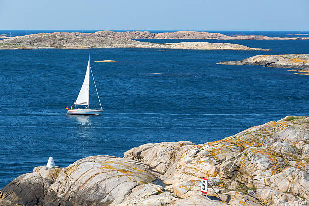 istock View of rocky archipelago with a sailing boat 2213659733