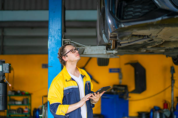 istock Blue collar workers are working at car service workshop. 2213662660