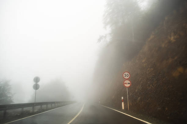 Mountain road in fog in the evening