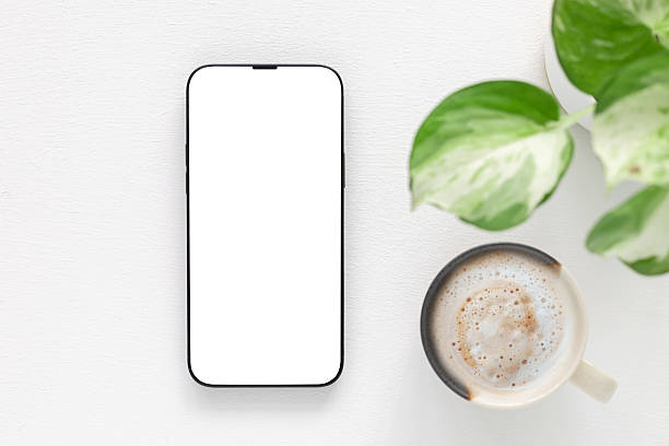 istock Top view, flat lay a modern smartphone with a blank white screen and coffee cup, plant over white background. Technology, lifestyle. 2213664637