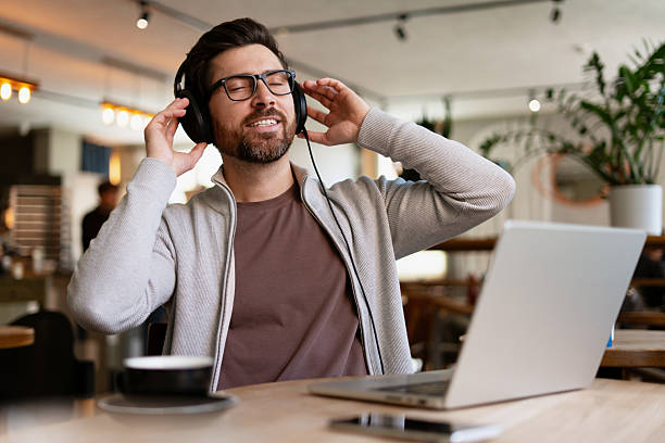 istock Freelancer enjoying music while working in a cafe 2213664957