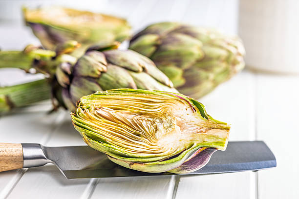istock Ripe artichokes plant on kitchen table. 2213666548