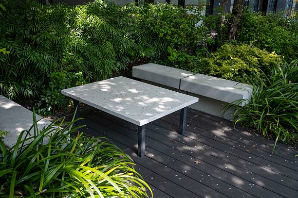 istock Garden seating area with concrete benches and table. 2213669053