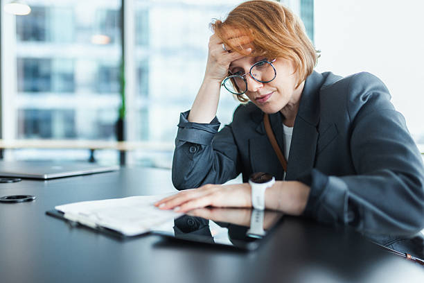Stressed Woman in Modern Office with Headache