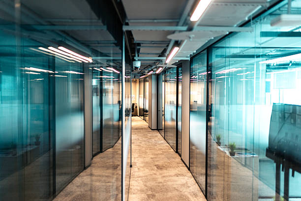 istock Modern office corridor with glass partitions and professional lighting 2213669394