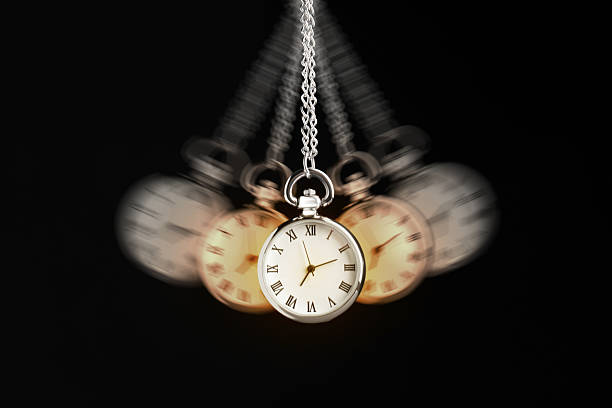 istock Hypnosis session. Vintage pocket watch swinging on black background, motion blur effect 2213670085