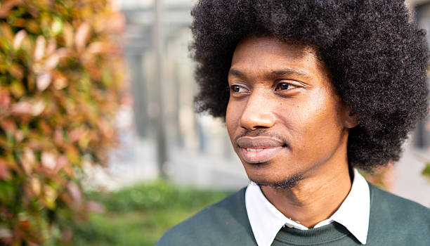 Young man outdoors showcasing positive expressions and thoughtful demeanor