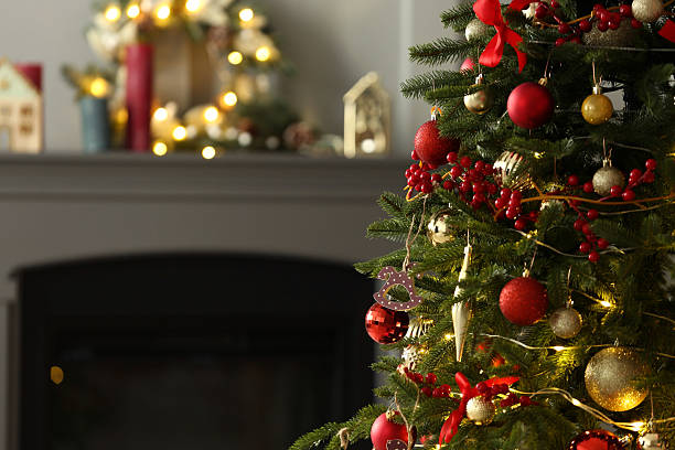 istock Beautiful decorated Christmas tree near fireplace at home, closeup. Space for text 2213670830