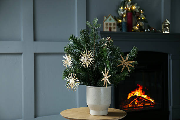 Decorated fir tree branches on table at home. Christmas decor