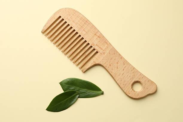 istock Wooden comb and leaves on beige background, flat lay 2213671096